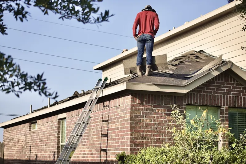 Professional roofer working on a residential roof in Steamboat Springs